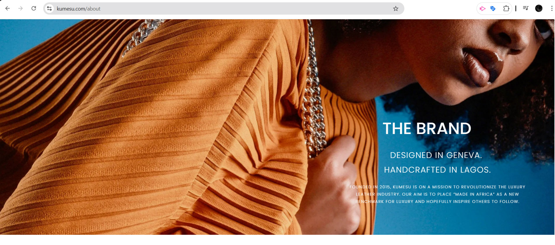 A close-up of textured orange fabric with a chain strap, highlighting a modern luxury design concept. The background is a vibrant blue.